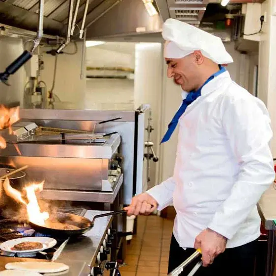 Shads Landing Chef Created Meals, chef frying a dish.